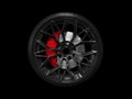 Car alloy wheel and tyre isolated on black background. New alloy wheel with tire and yellow carbon ceramic brakes. Alloy rim Royalty Free Stock Photo