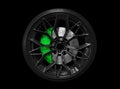 Car alloy wheel and tyre isolated on black background. New alloy wheel with tire and yellow carbon ceramic brakes. Alloy rim Royalty Free Stock Photo