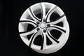 car alloy wheel, unusual white with black paint on the spokes. The disk for autotuning, beautiful Royalty Free Stock Photo