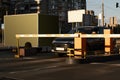 Car approaching to automatic barrier gates for supermarket parking lot. Security system for car park entry to shopping