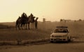 Car and Arabs on camels in the desert of Egypt Royalty Free Stock Photo