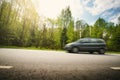 Car on asphalt road in beautiful spring day