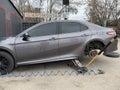 Car in a car service, repair of wheels. Concept: tire fitting, vulcanization, tire change. Car on a jack, changing wheels. Kiev