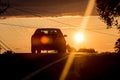 Car from the back driving towards the sunset Royalty Free Stock Photo