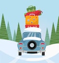 Car back View With stack of baggage on background of snow trees. Blue car with suitcases on the roof. Winter family traveling by