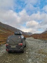 A car on the background of an autumn Arctic landscape in the Khibiny mountains. Kirovsk, Kola Peninsula, Polar Russia