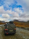 A car on the background of an autumn Arctic landscape in the Khibiny mountains. Kirovsk, Kola Peninsula, Polar Russia