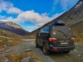 A car on the background of an autumn Arctic landscape in the Khibiny mountains. Kirovsk, Kola Peninsula, Polar Russia