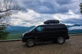 A car on the background of a view of the Lago-Naki plateau in Adygea. The Caucasus Mountains. Russia 2021