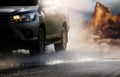 Car with big puddle of water spray from the wheels through flood water after hard rain.