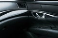 Car black perforated leather interior details of door handle witCar black perforated leather interior details of door handle with Royalty Free Stock Photo