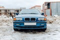 car BMW 3 Series E46 318i on the background of construction site. Fourth generation of compact executive blue colour car in winter