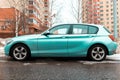car BMW 1 series F20 on the urban parking, side view