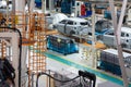 Car bodies are on assembly line. Factory for production of cars. Modern automotive industry. Electric car factory