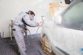 Car body painter spraying paint on bodywork parts Royalty Free Stock Photo