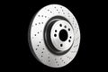 Car brake disc isolated on black background. Auto spare parts. Perforated brake disc rotor isolated on black. Braking ventilated