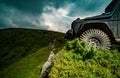 Car brakes with absorbers. Car tire. Tire for offroad. Truck car wheel on offroad steppe adventure trail. Wheel close up Royalty Free Stock Photo