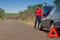 Car breakdown - African American woman call for help, road assistance.