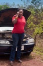 Car breakdown - African American woman call for help, road assistance.