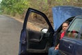 Car breakdown - African American woman wait for he