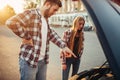 Car breakdown, man and woman against open hood Royalty Free Stock Photo