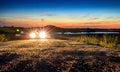 Car with bright light in beautiful mountain landscape sunset sun Royalty Free Stock Photo