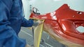 Car bumper after painting in a cars spray booth. Auto vehicle primer bumper.