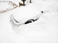 Car buried in snow.