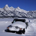 Car Buried in Snow in Winter with Teton Mountains in Background Royalty Free Stock Photo