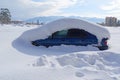 Car is buried under thick layer of snow