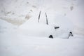 Car buried under a thick layer of snow after snow storm