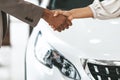 Car Buyer And Auto Seller Shaking Hands In Dealership Store Royalty Free Stock Photo