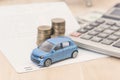 Car with calculator and money on wood table. auto loan concept Royalty Free Stock Photo