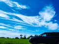 Car in a camping by the sea with a green grass and a bright blue sky Royalty Free Stock Photo