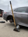 Car in a car service, repair of wheels. Concept: tire fitting, vulcanization, tire change. Car on a jack, changing wheels. Kiev