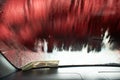 Car Care Business. Automatic Car Wash Process. Spray foam bubble shampoo on the car surface and Tire. Royalty Free Stock Photo