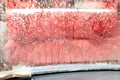 Car Care Business. Automatic Car Wash Process. Spray foam bubble shampoo on the car surface and Tire. Royalty Free Stock Photo