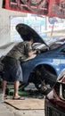 Car care maintenance and servicing, Close-up hand technician auto mechanic using the wrench to repairing. Bekasi, Indonesia,
