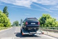 Car carrier trailer with car. Car transported on evacuation tow truck on highway