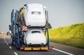 Car Carrier Trailer Full of Vehicles Driving Down the Highway