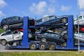 Car carrier trailer with used cars for sale on bunk platform Royalty Free Stock Photo