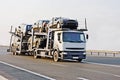 Car carrier truck deliver new auto batch to dealer