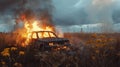 the car caught fire in a field with a strong flame Royalty Free Stock Photo