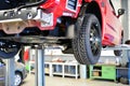 car for changing tyres on a lifting platform in the workshop- closeup profile of a tyre Royalty Free Stock Photo