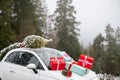 Car with Christmas tree decorated with presents Royalty Free Stock Photo