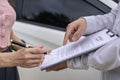 Car claim process Insurance agent after car accident writes on clipboard while inspecting Royalty Free Stock Photo