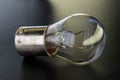 Car classic halogen bulb. Filament, glass and metal, high energy consumption. Black background. Close-up view. P21w, turn signal