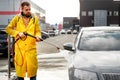 Car close-up. Car wash. Manual car wash with pressurized water in car wash outside. Royalty Free Stock Photo