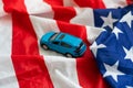 car and colourful stars on a blue background, American bailout car money