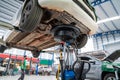 A car that comes to change the engine oil in Car repair station paved with epoxy floor and electric lift